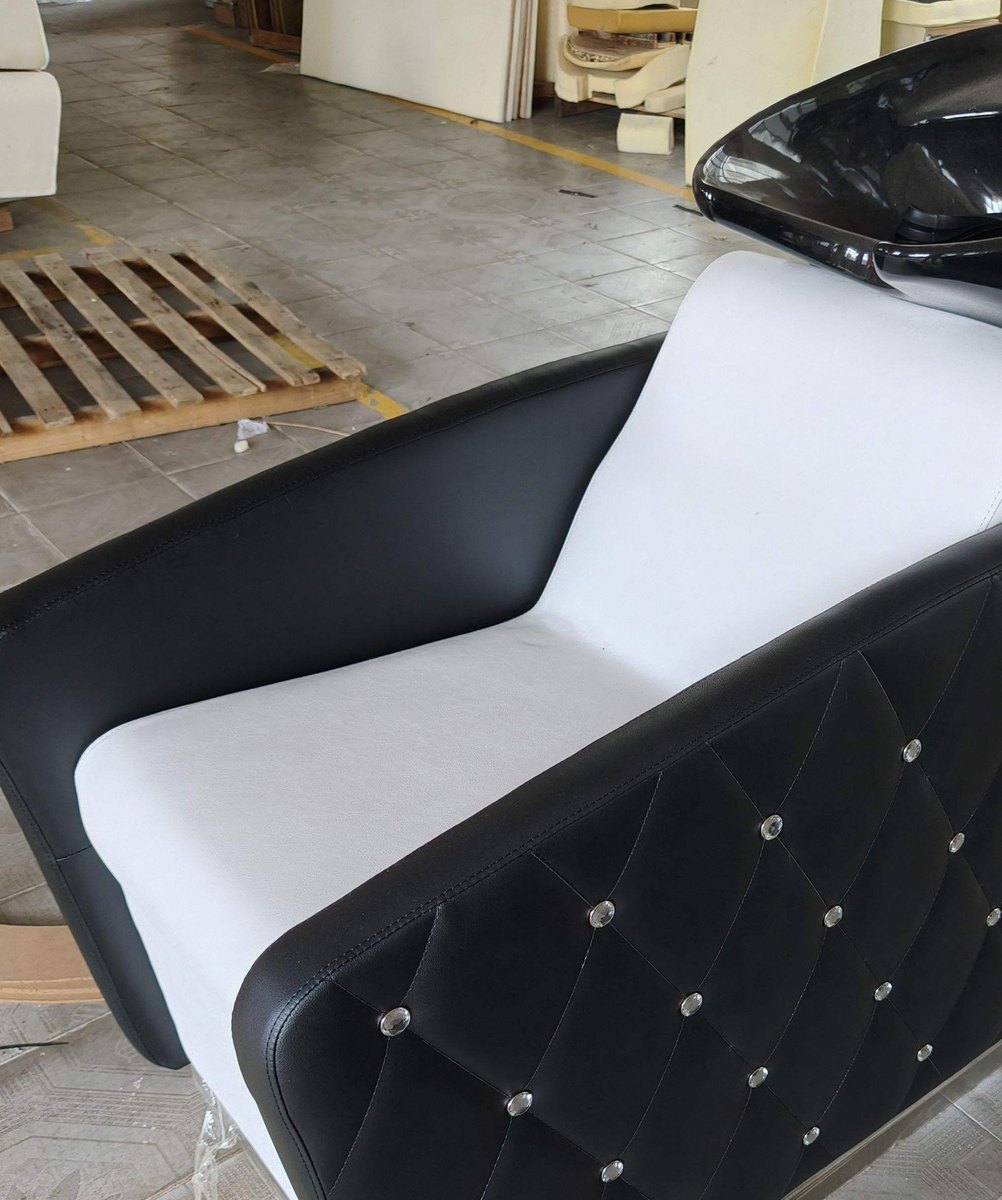 Black and white backwash unit photographed on the factory floor before crating