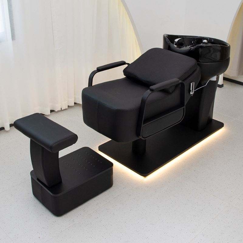 Black backwash shampoo unit with ceramic bowl and foot stool