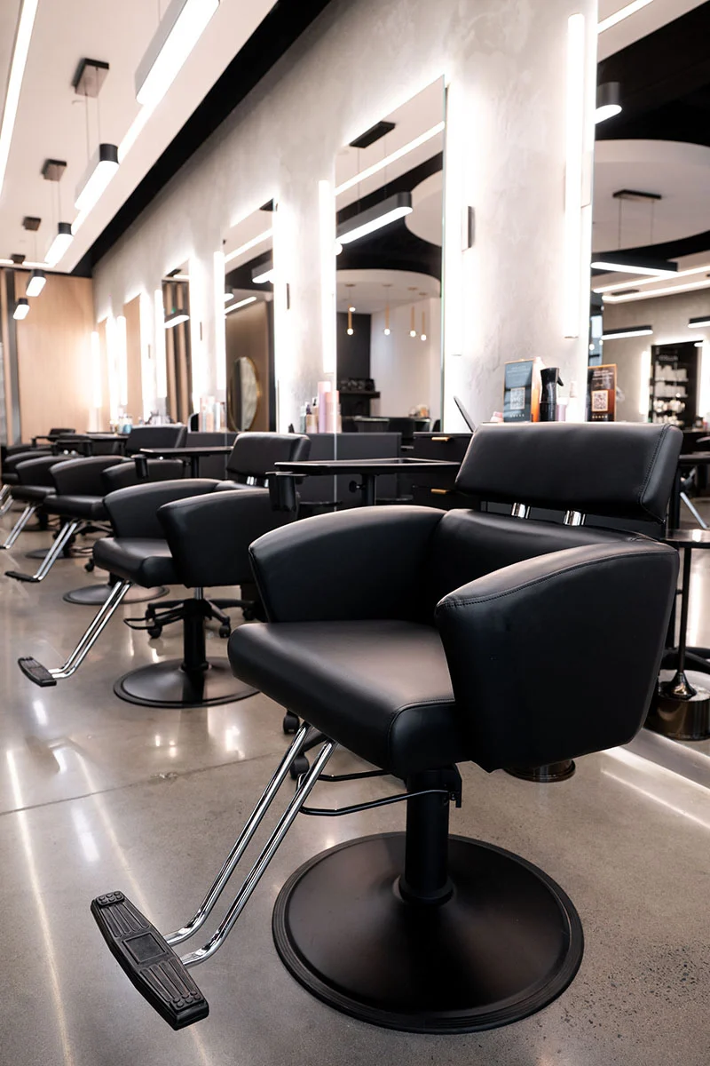 Salon interior furnished with matched styling chairs and stations